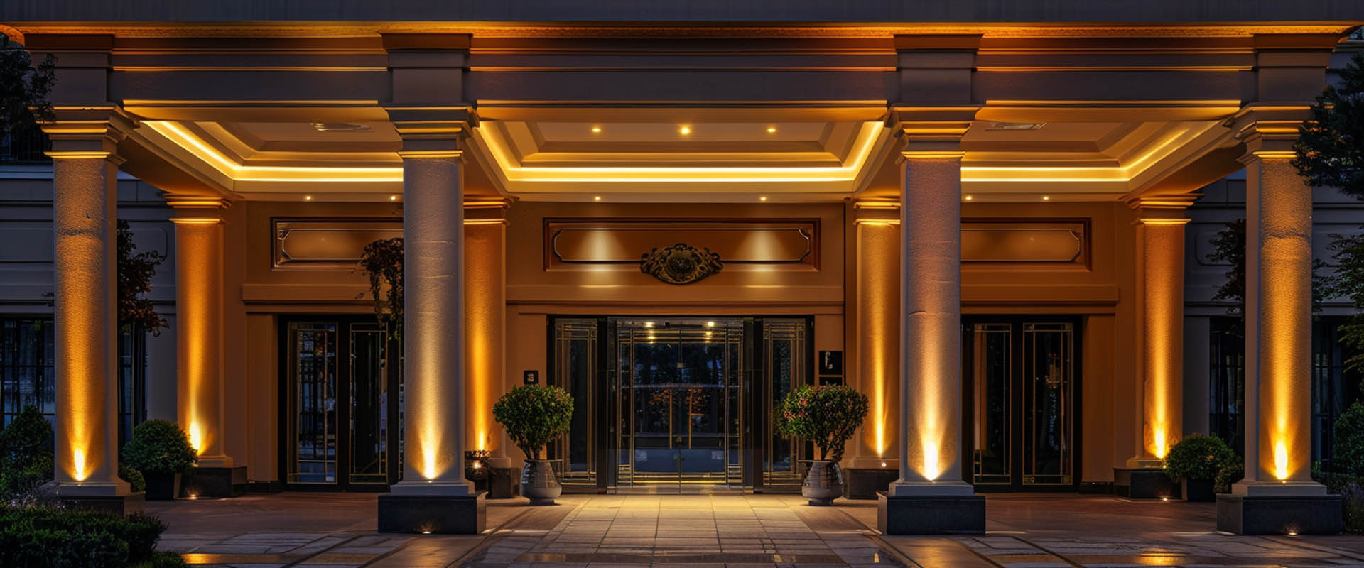 Hotel facade architectural lighting with warm wall washer lights at entrance