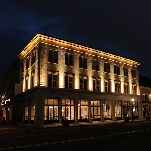 traditional facade lighting with warm white uplights and uneven illumination on building exterior