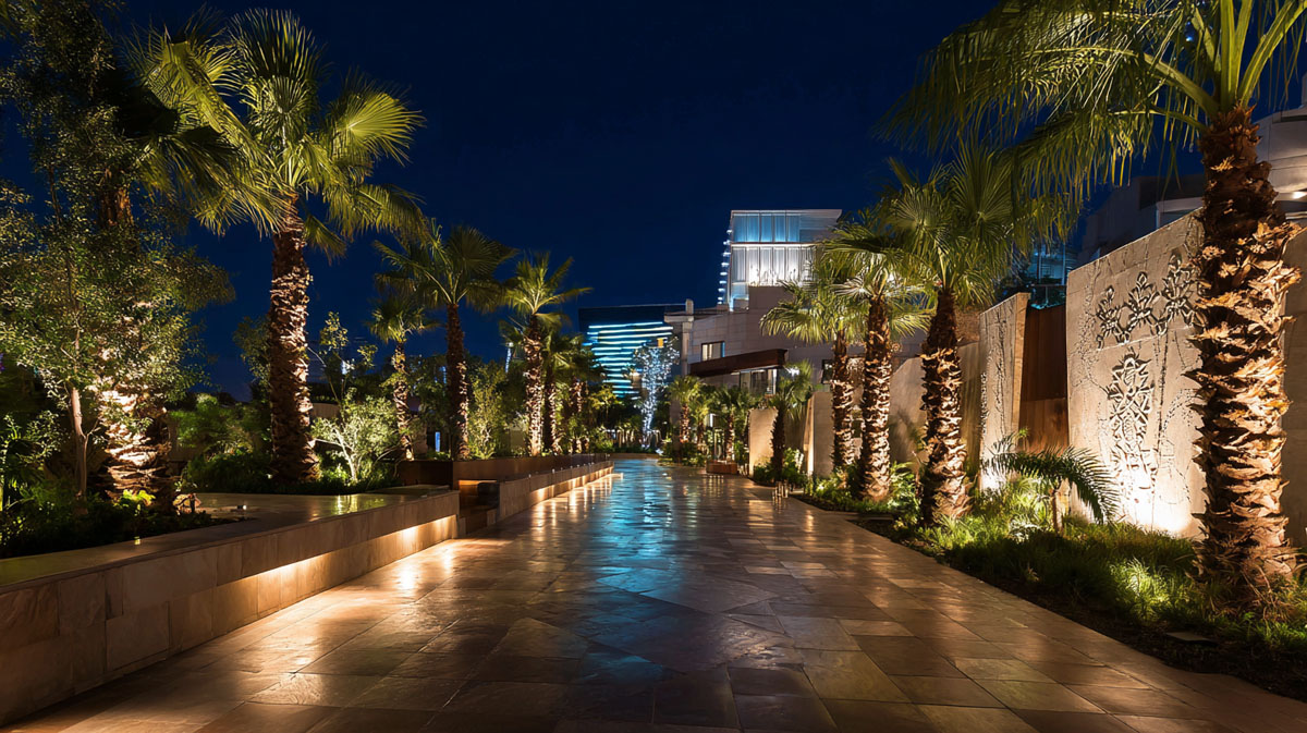 hotel-landscape-led-inground-lights Luxury hotel landscape with LED inground lights illuminating pathways and palm trees at night